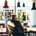 man in chair with table beside coffee