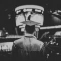 man in academic dress wearing mortar cap