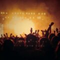 band performing on stage in front of people